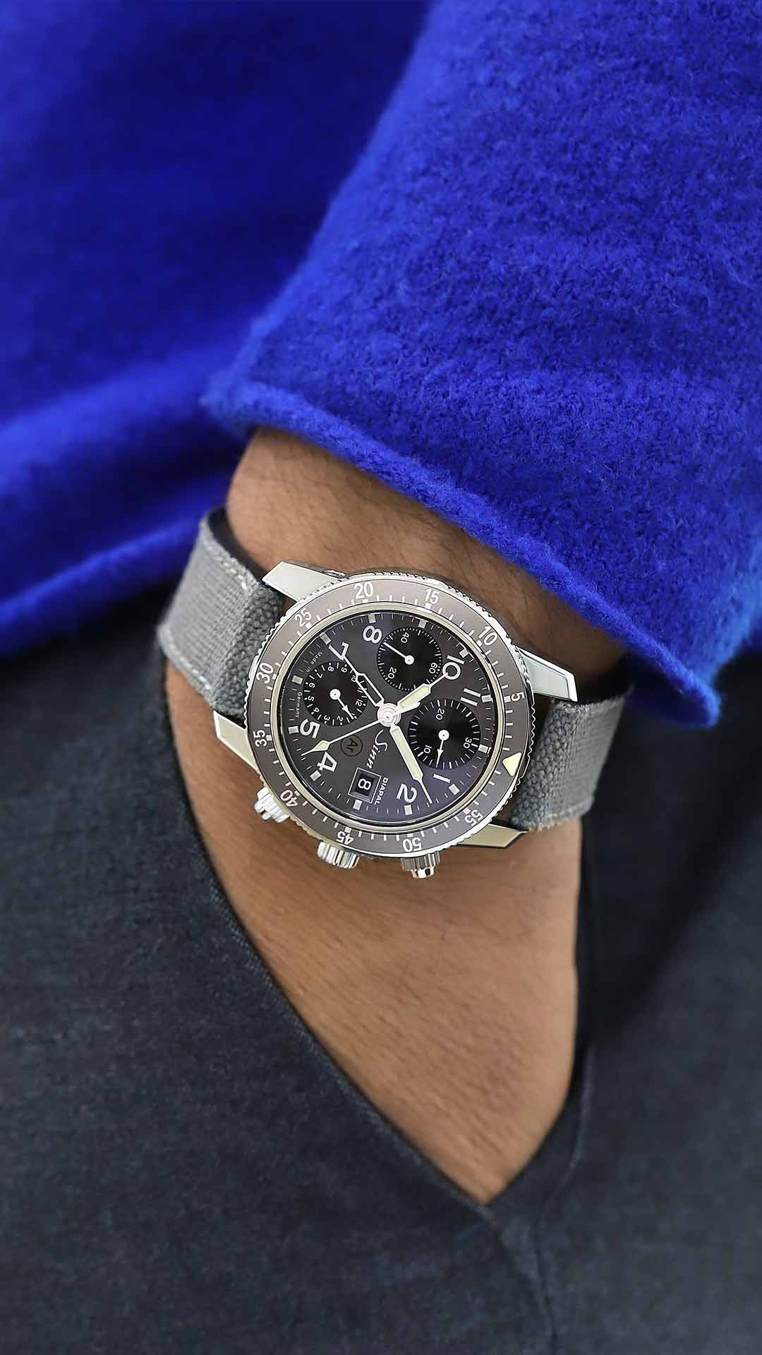 Sinn 103 St DIAPAL pilot chronograph with black dial and canvas leather strap worn on the wrist.