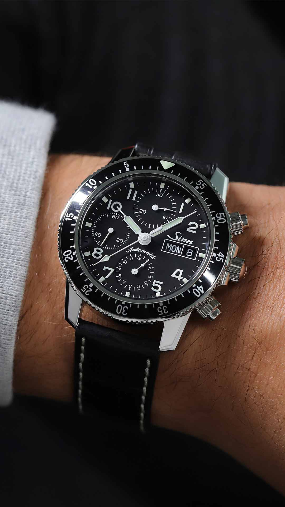Sinn 103 St Sa pilot chronograph with black dial and leather strap on the wrist.
