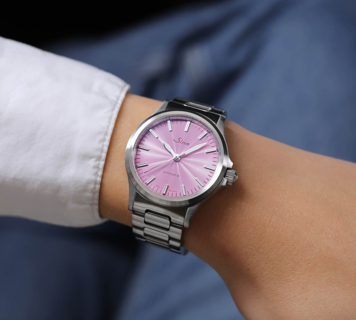 The 556 with an mauve coloured dial on a woman's wrist