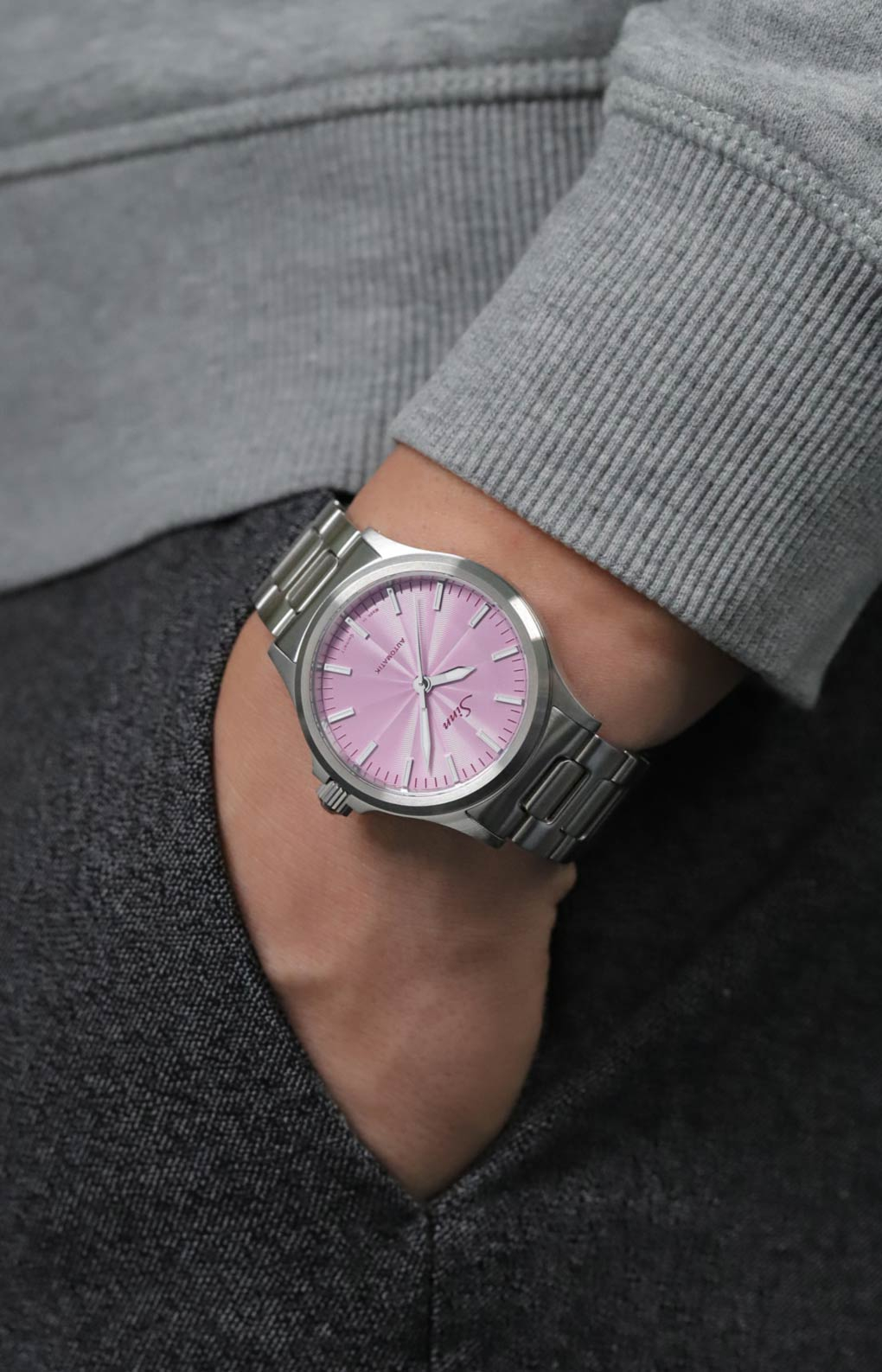The 556 with an mauve coloured dial on a man's wrist