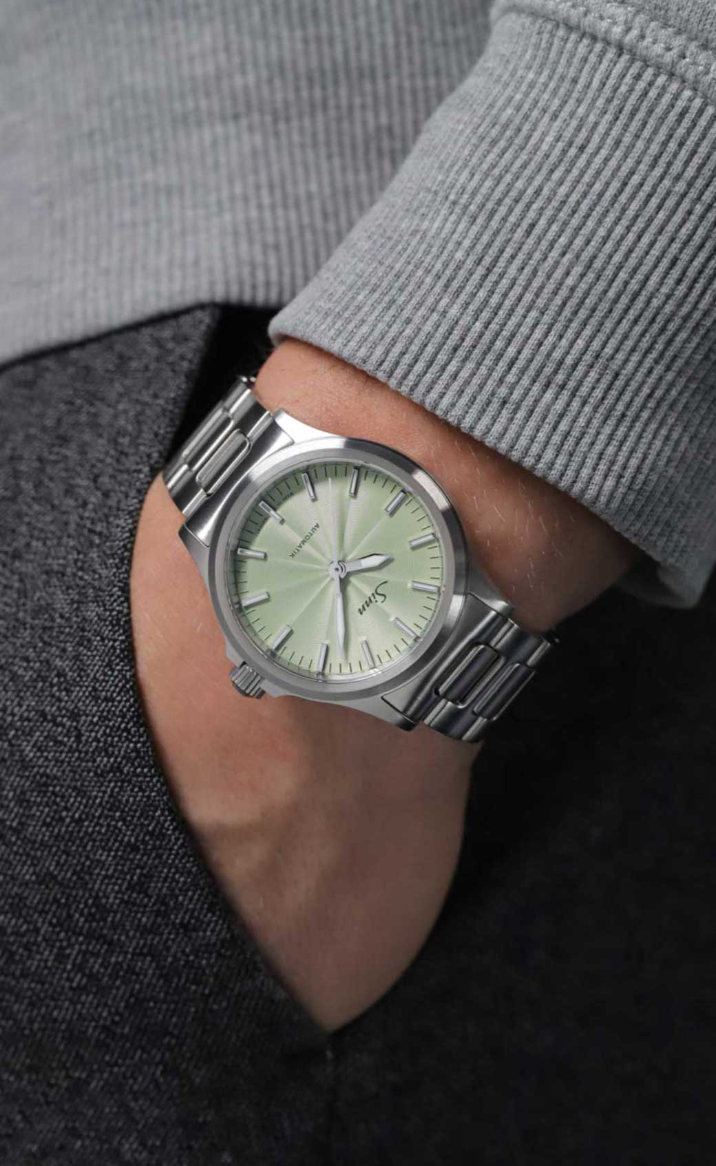 The 556 with a sage dial on a man's wrist