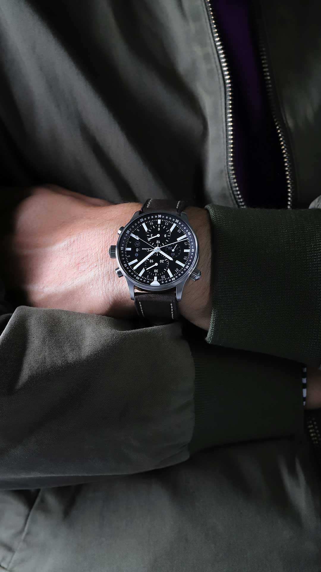 Sinn 900 Flieger am Handgelenk mit Lederband und Fliegerjacke.