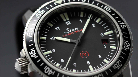 Close-up of the Sinn EZM 3 with black dial and luminous hands.