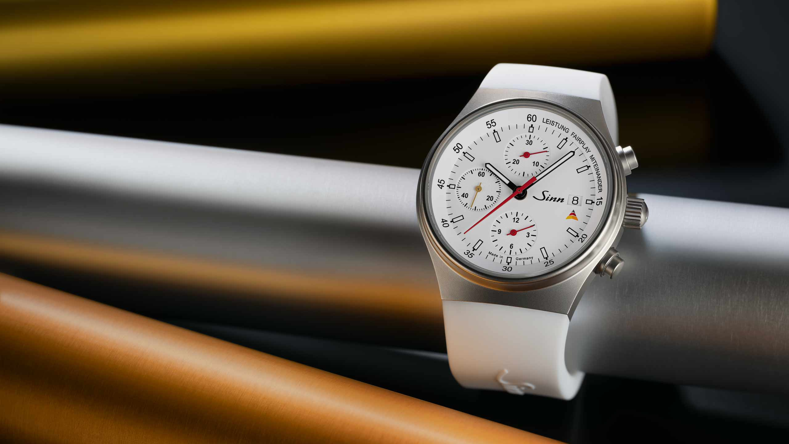                       Sinn model 144 St Sa Sporthilfe chronograph with white dial and white silicone strap.
                  