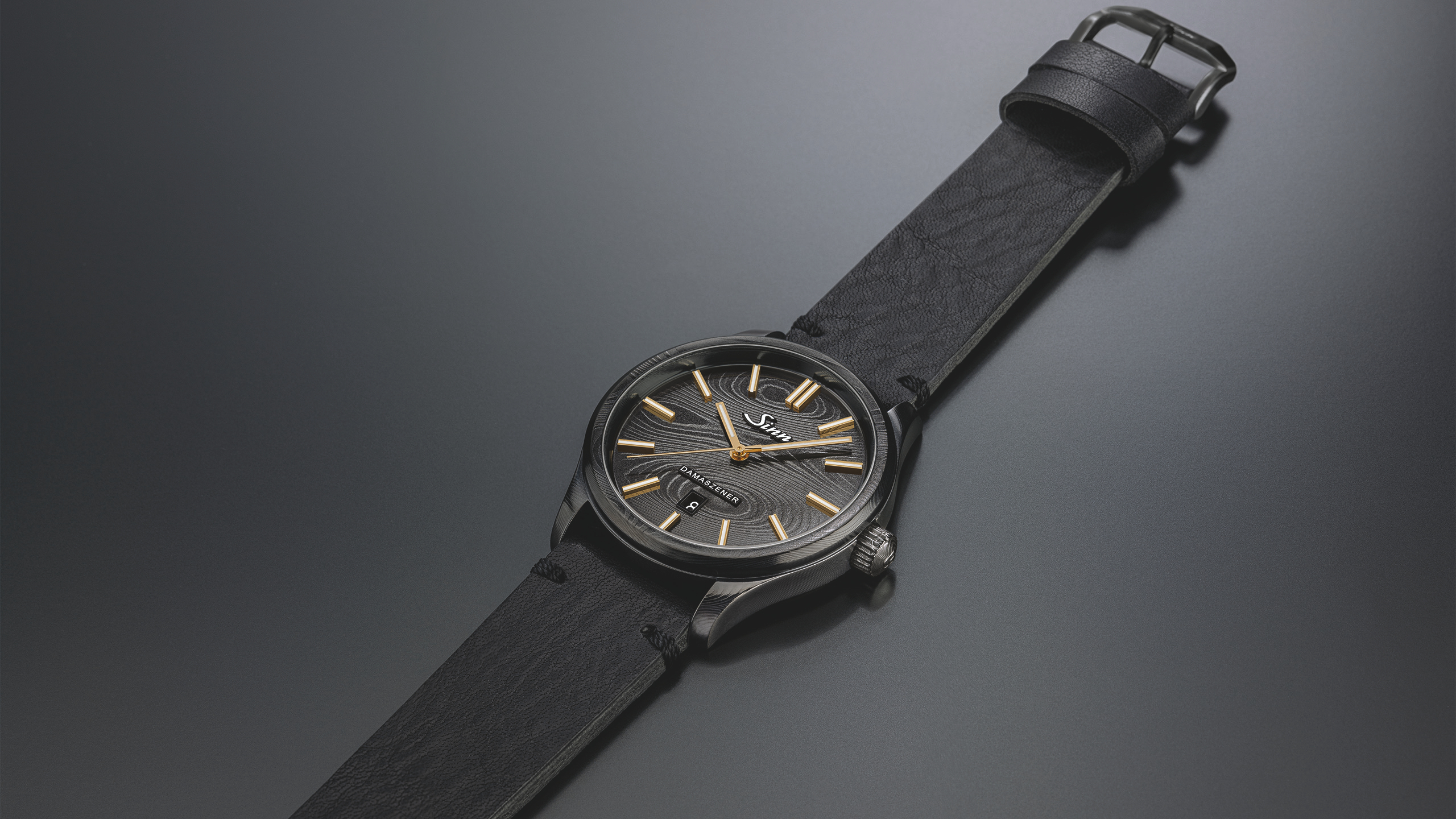 Sinn 1800 S GG DAMASZENER with gold details on black Damascus steel and leather strap.