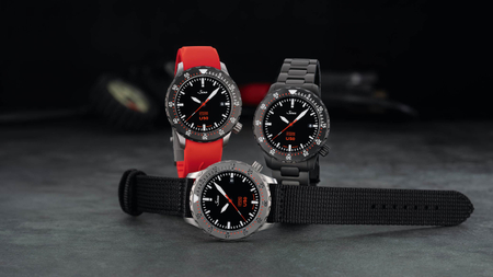 Sinn U50 HYDRO with textile strap, U50 SDR HYDRO with red silicone strap and U50 S HYDRO with black metal bracelet, on dark background.