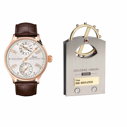 Sinn REGULATEUR 6100 Roségold neben einer Goldene-Unruh-Trophäe aus dem Jahr 2008.