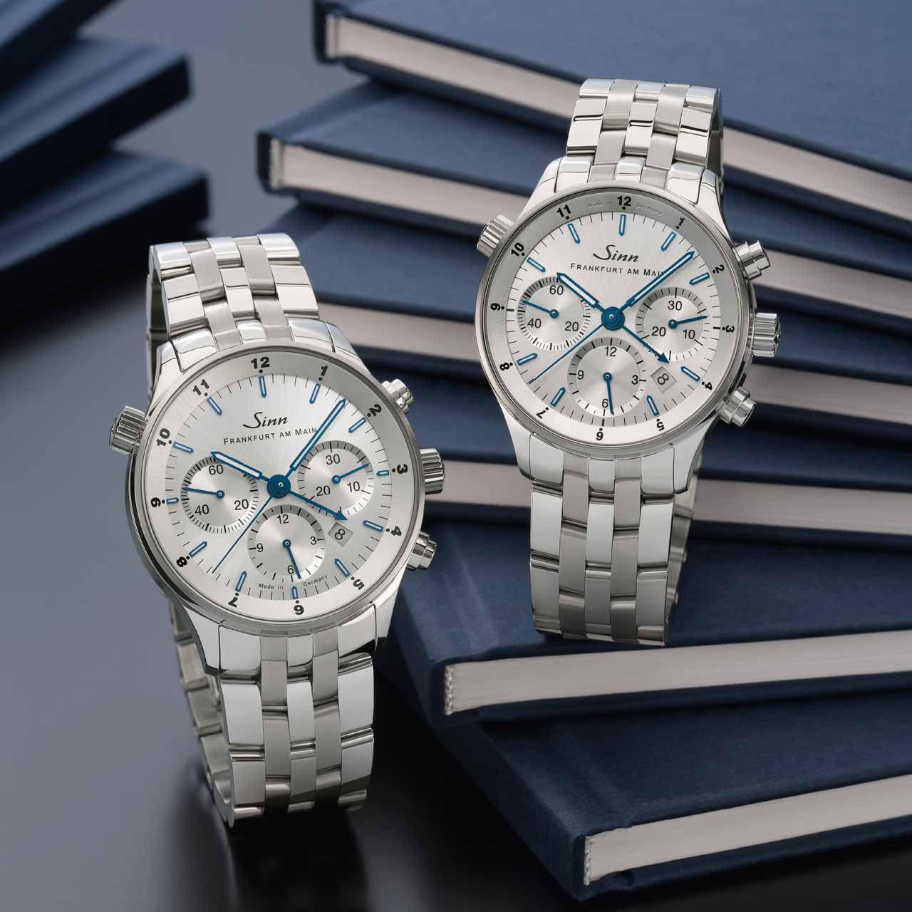 Frankfurt Financial District watches 6000 Anniversary III and 6099 Anniversary III with silver dials and stainless steel bracelets.
